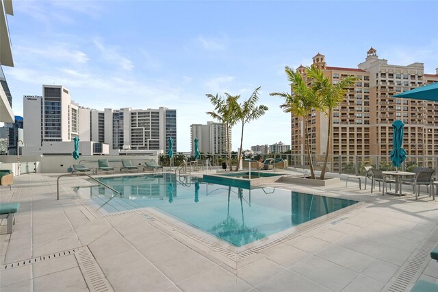 community pool featuring a city view and a patio