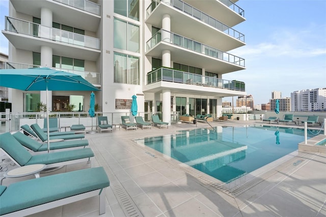 community pool featuring a city view and a patio