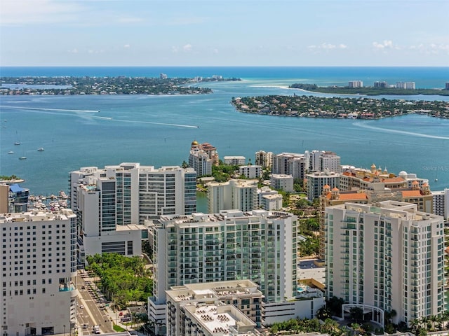 birds eye view of property with a water view and a city view