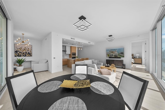 dining space with recessed lighting, visible vents, and a notable chandelier