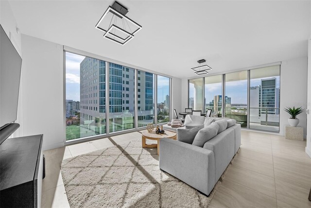 living area featuring a wall of windows, a view of city, and tile patterned floors