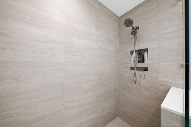 full bathroom featuring tiled shower