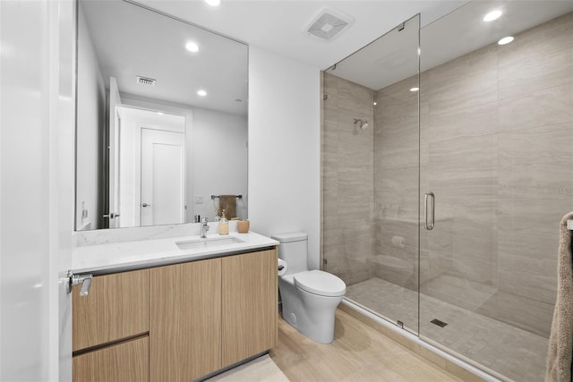 bathroom featuring recessed lighting, visible vents, toilet, a stall shower, and vanity