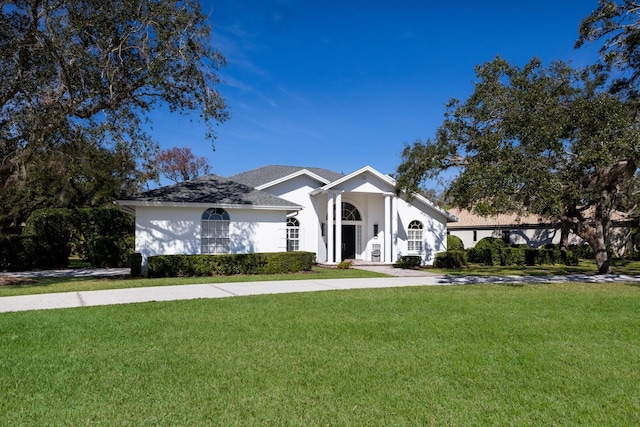 view of front of house with a front lawn and stucco siding