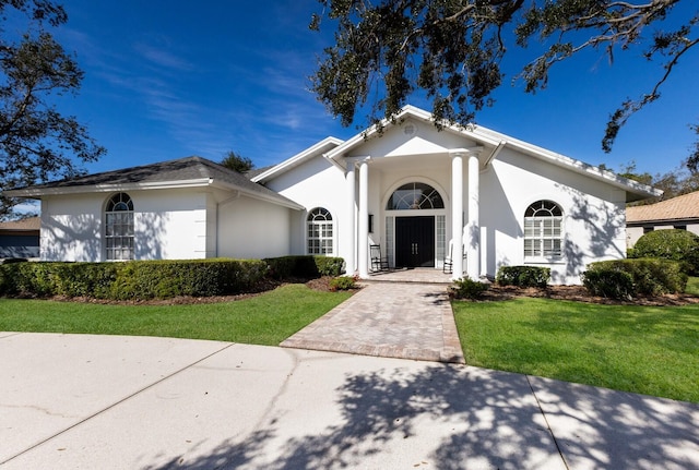 mediterranean / spanish-style home featuring stucco siding and a front yard