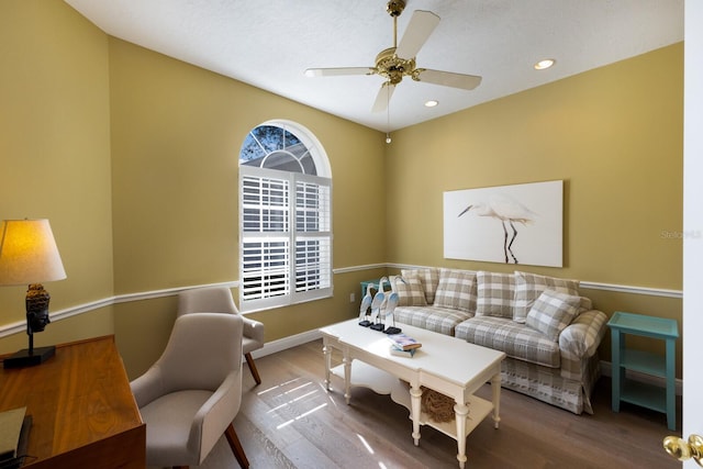 living area featuring ceiling fan, baseboards, wood finished floors, and recessed lighting