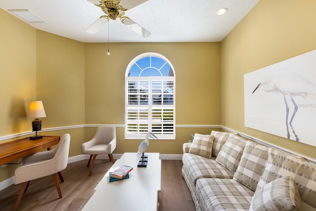 living area featuring ceiling fan, wood finished floors, and baseboards