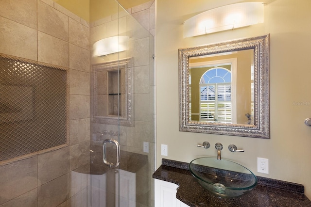 full bathroom featuring a shower stall and vanity