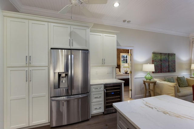 kitchen with stainless steel fridge with ice dispenser, wine cooler, light stone counters, open floor plan, and crown molding