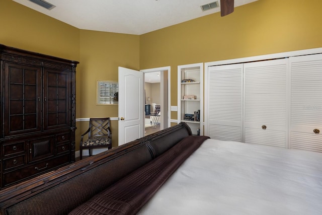 bedroom featuring vaulted ceiling, a closet, and visible vents