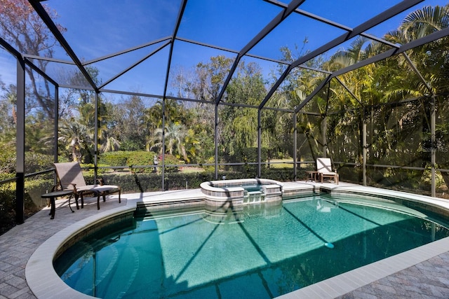 view of pool featuring a patio, glass enclosure, and a pool with connected hot tub