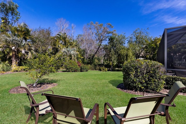 view of yard featuring glass enclosure