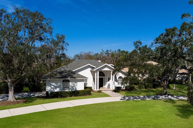 view of front of property featuring a chimney and a front yard