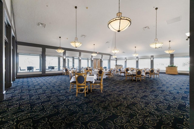 unfurnished dining area featuring visible vents and carpet flooring