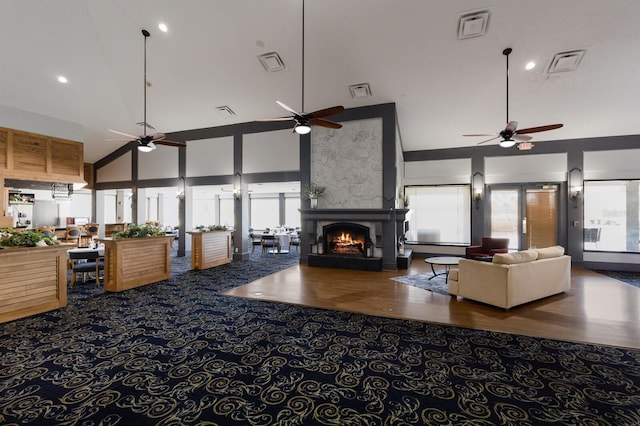 living room featuring plenty of natural light, a fireplace, and visible vents