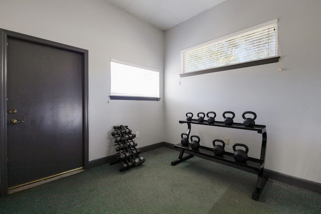 workout area with carpet flooring and baseboards