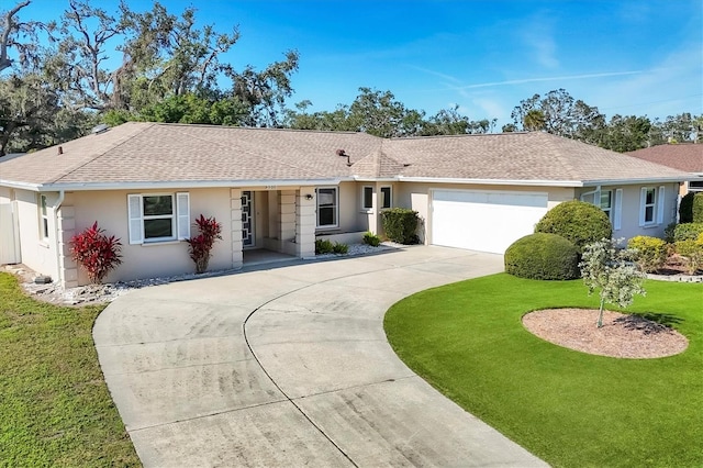 ranch-style home featuring a garage and a front lawn