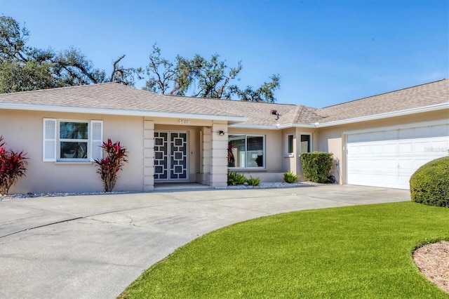 ranch-style home with a garage and a front yard