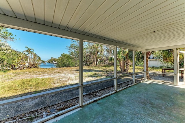 unfurnished sunroom featuring a water view