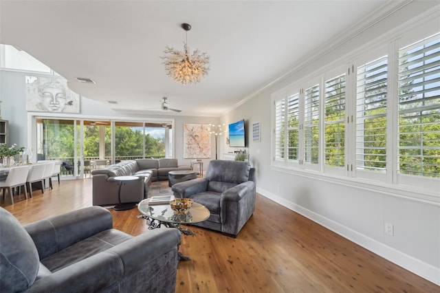 living room with hardwood / wood-style flooring, ornamental molding, and ceiling fan