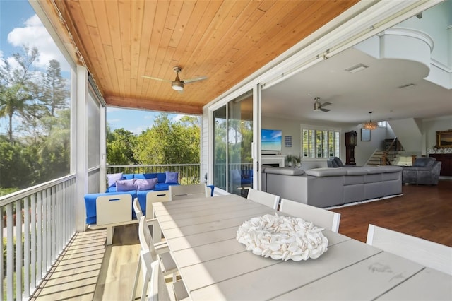 sunroom / solarium with wood ceiling and ceiling fan