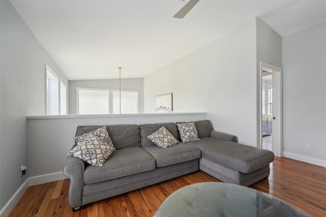 living room featuring hardwood / wood-style flooring and vaulted ceiling