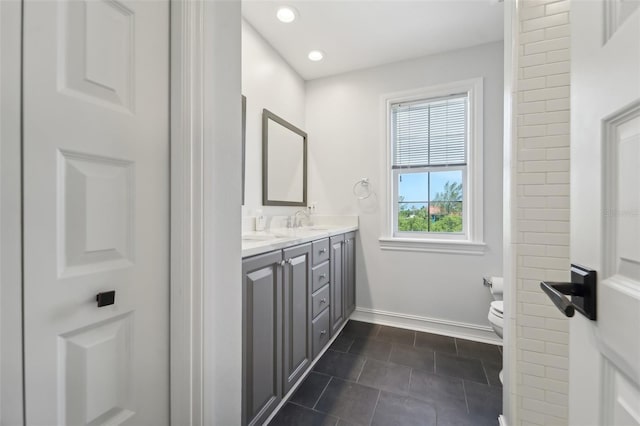 bathroom featuring vanity, tile patterned flooring, and toilet