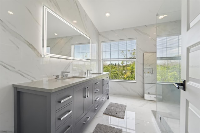 bathroom with vanity, tile walls, and a shower