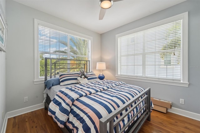 bedroom with dark hardwood / wood-style floors and ceiling fan