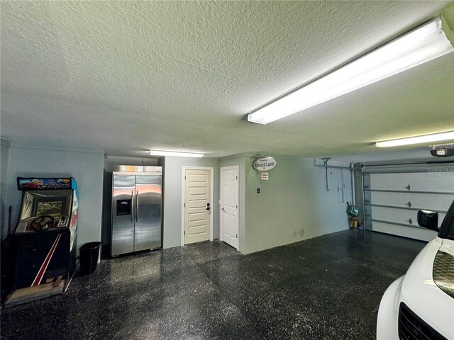 garage featuring built in refrigerator and a garage door opener