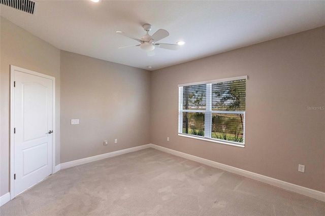 empty room featuring light carpet and ceiling fan