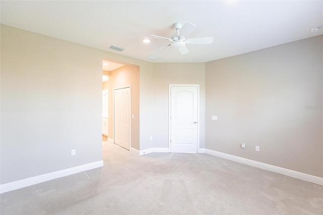 unfurnished bedroom featuring light carpet, ceiling fan, and a closet