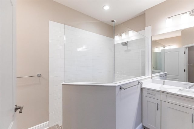 bathroom with vanity and tiled shower