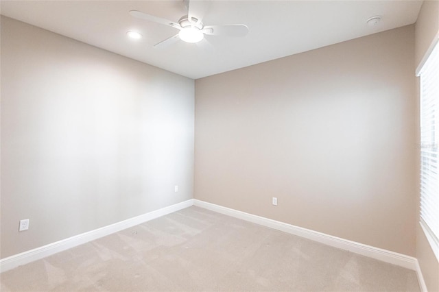 carpeted spare room with ceiling fan