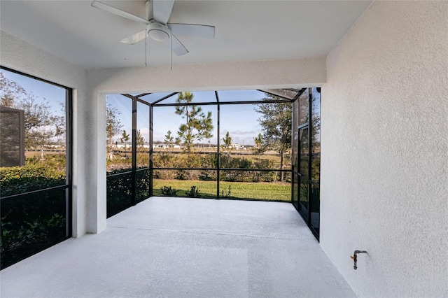 sunroom featuring ceiling fan