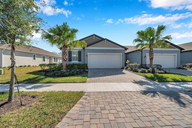 ranch-style house with a garage and a front yard