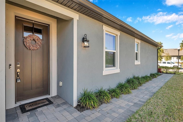 entrance to property with stucco siding