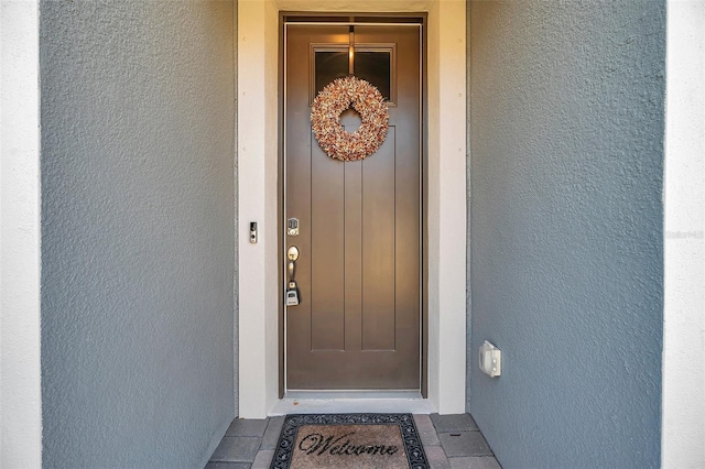 property entrance with stucco siding