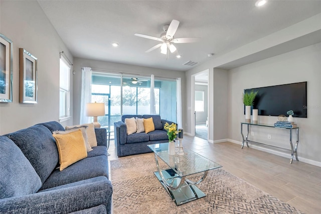 living room with a ceiling fan, recessed lighting, visible vents, and baseboards