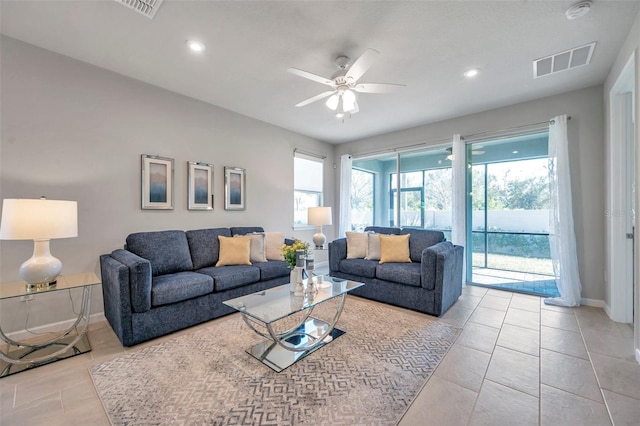 tiled living room with baseboards, visible vents, a ceiling fan, and recessed lighting