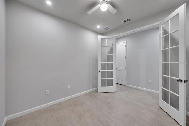 spare room with ceiling fan and french doors