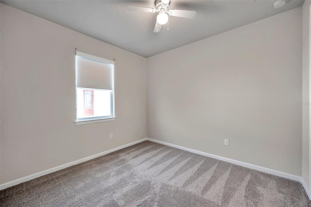 unfurnished room with carpet floors, baseboards, and a ceiling fan