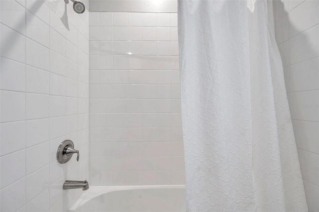 bathroom with shower / bath combo with shower curtain