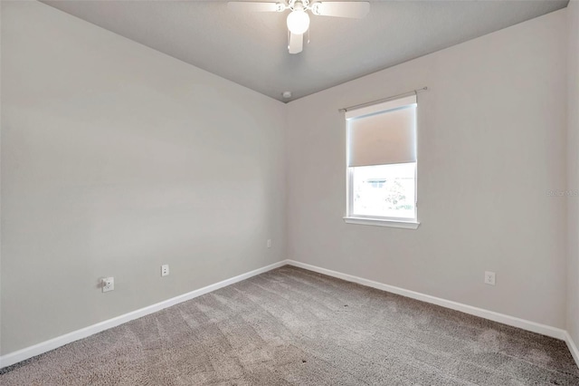 carpeted spare room featuring ceiling fan