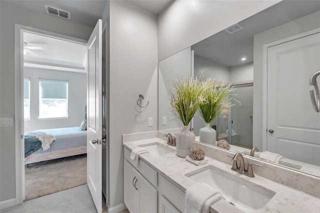 ensuite bathroom featuring visible vents, a sink, and double vanity