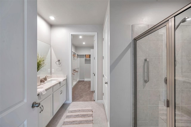 bathroom featuring vanity and a shower with shower door