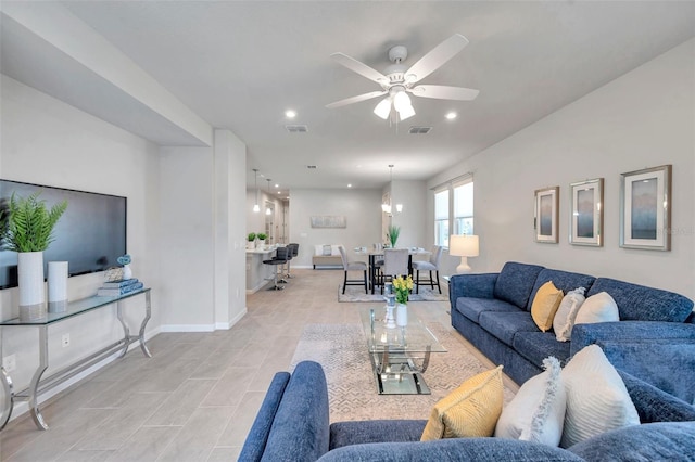 living area featuring ceiling fan, recessed lighting, visible vents, and baseboards