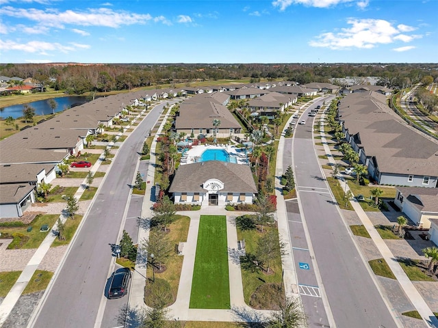 birds eye view of property with a water view and a residential view