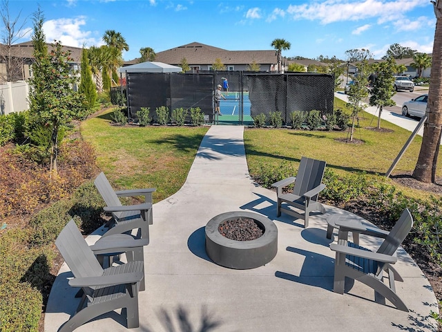 surrounding community with a fire pit, a patio area, fence, and a gate