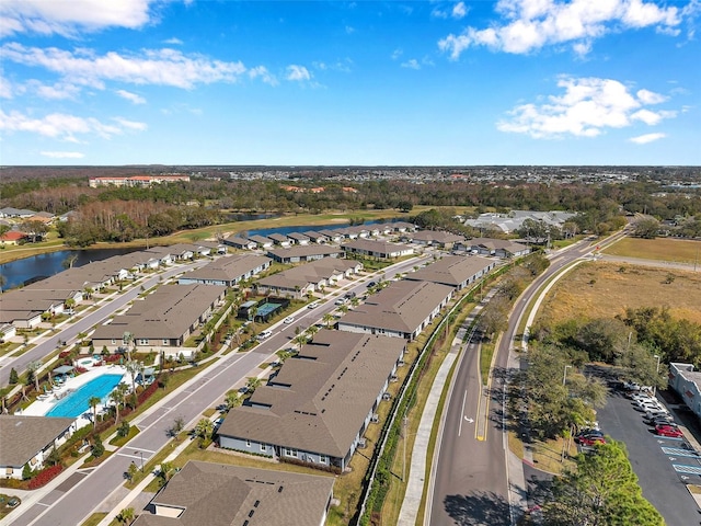 birds eye view of property with a water view and a residential view